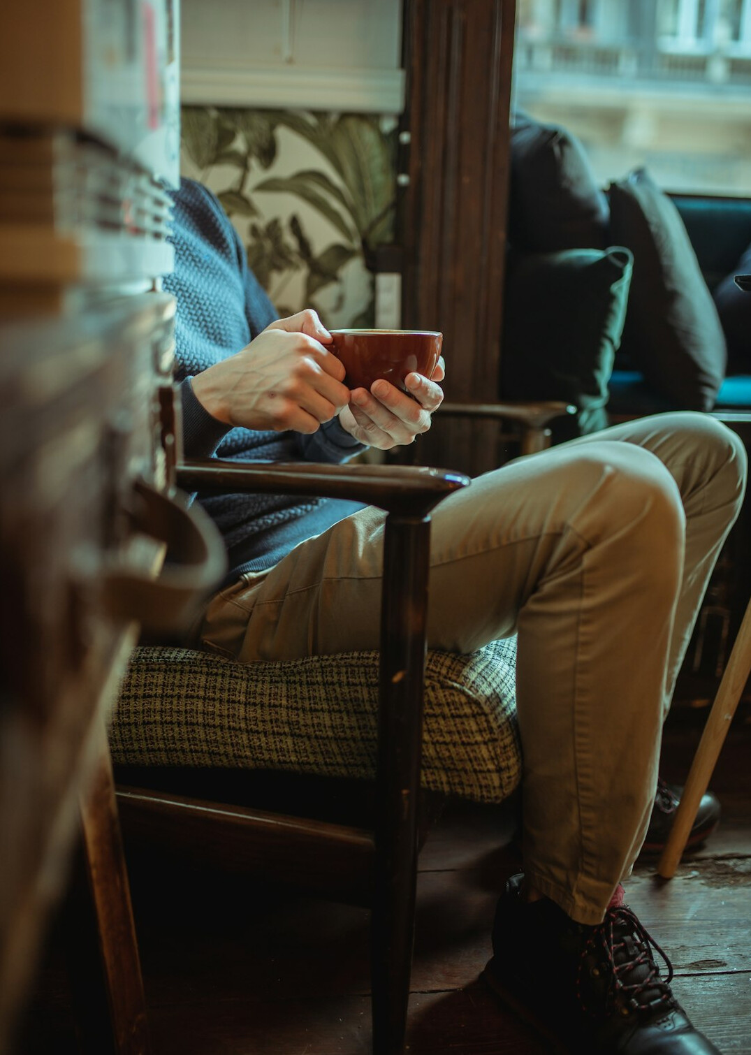 person reading book at cafe